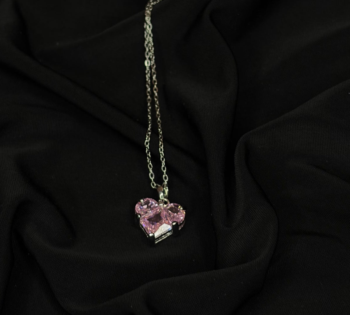 Silver-tone necklace with pink geometric crystal pendant