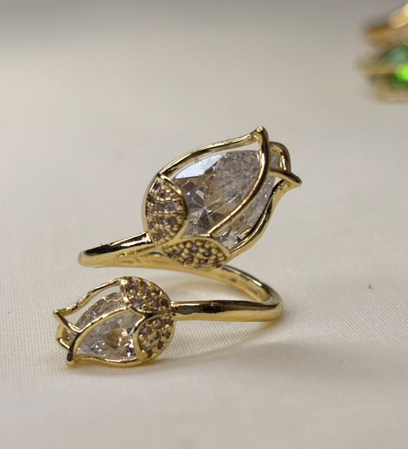 Gold-tone leaf-inspired ring with clear gemstone
