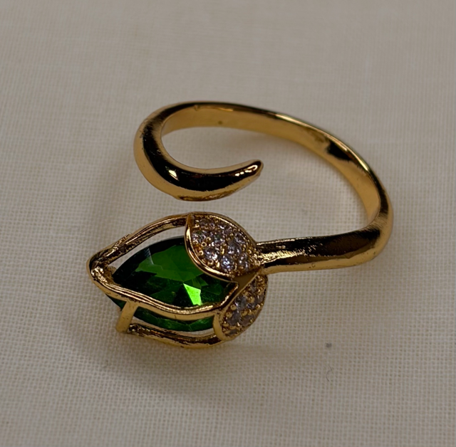 Gold-tone leaf-inspired ring with green gemstone