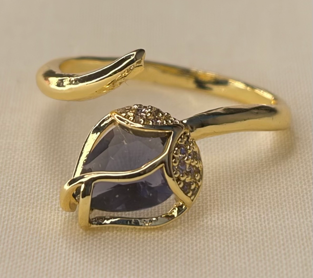 Gold-tone leaf-inspired ring with purple gemstone
