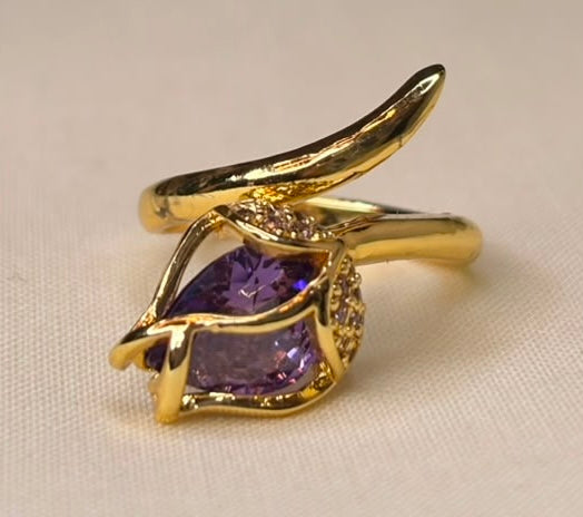 Gold-tone leaf-inspired ring with purple gemstone