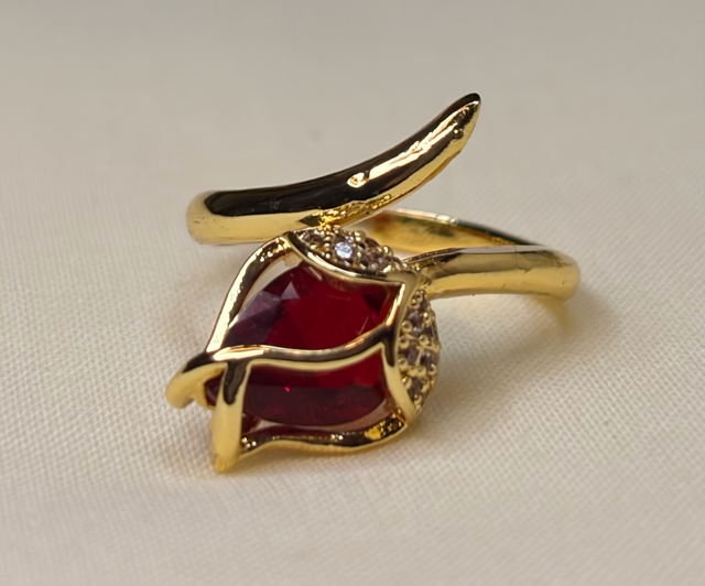 Gold-tone leaf-inspired ring with red gemstone